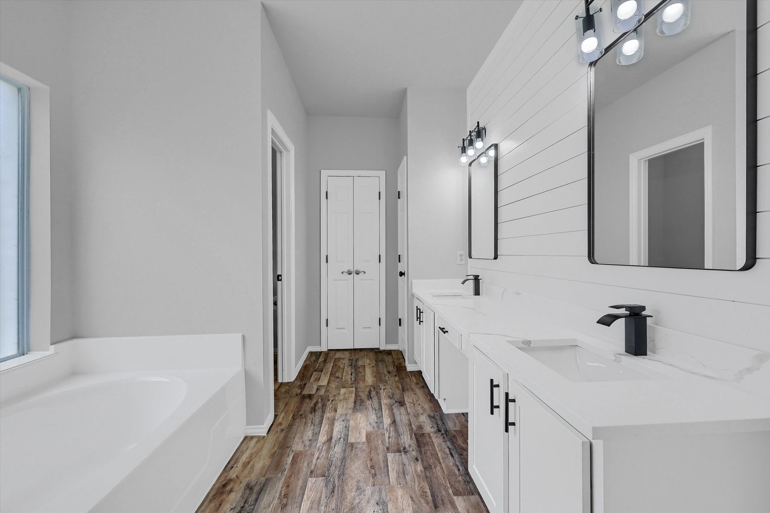 The master bathroom was updated with a beautiful shiplap design and features a large walk-in closet.